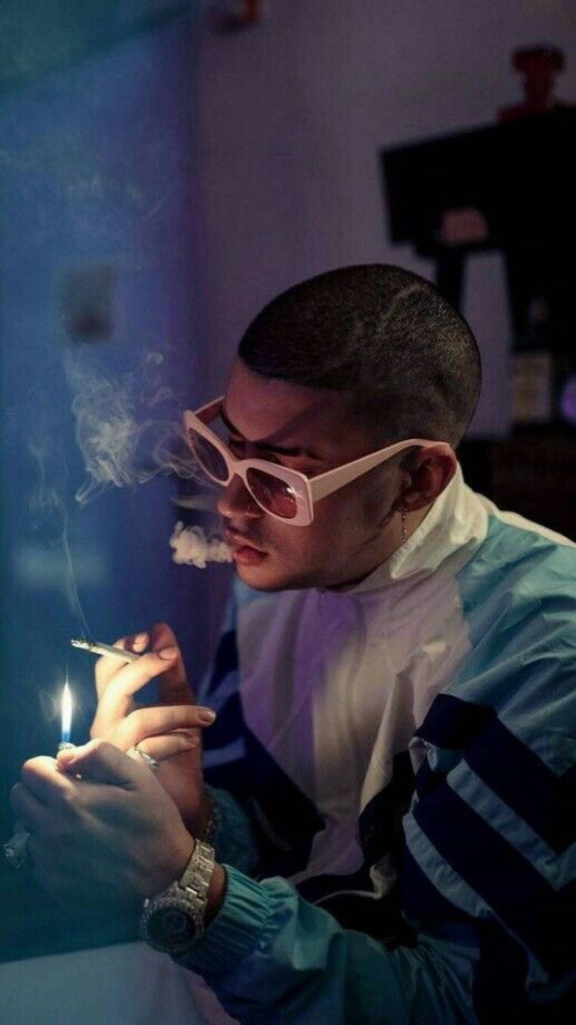 1130x2000 Download Bad Bunny Lighting A Cigarette Wallpaper, Phone