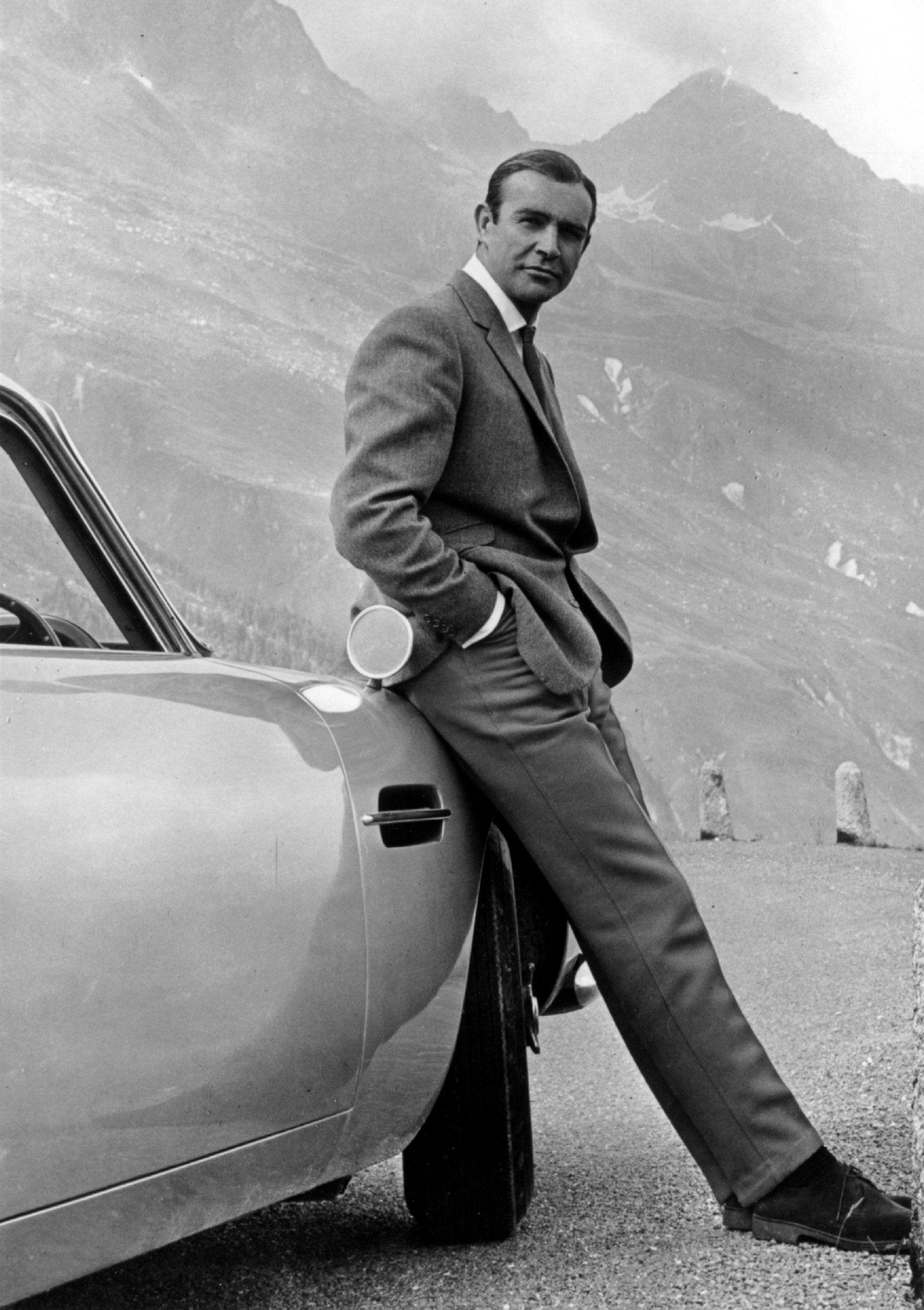 1830x2600 PHOTO: Actor Sean Connery poses as James Bond next to his Aston, Phone