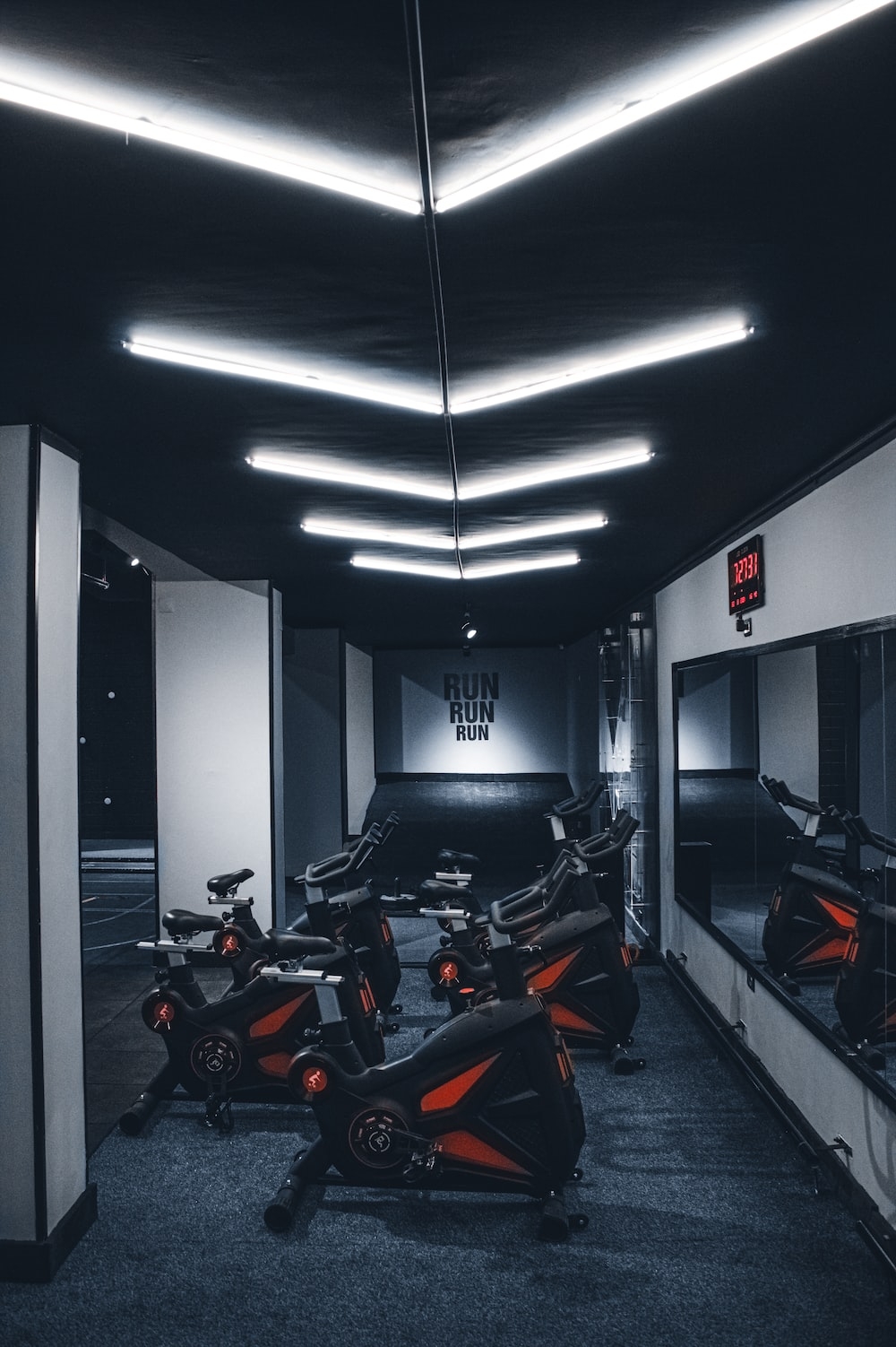 1000x1510 A gym with a row of stationary exercise bikes photo, Phone