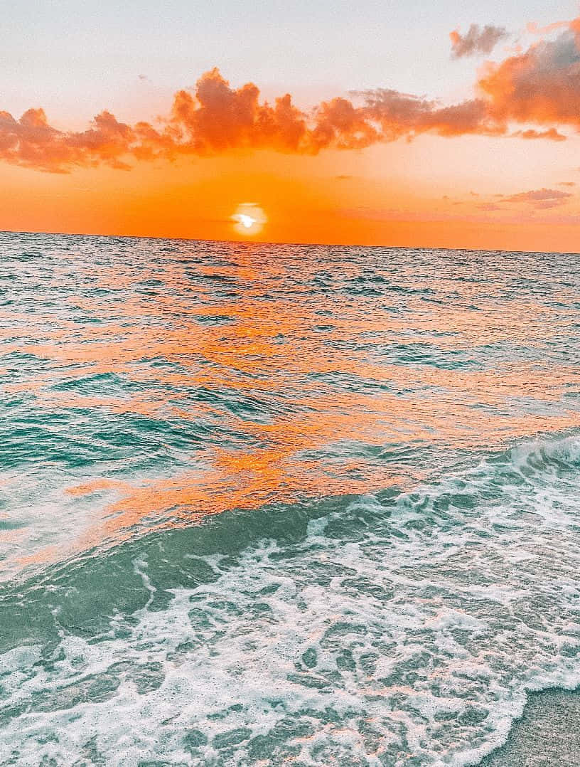 820x1080 Download A Sunset Over The Ocean With Waves, Phone