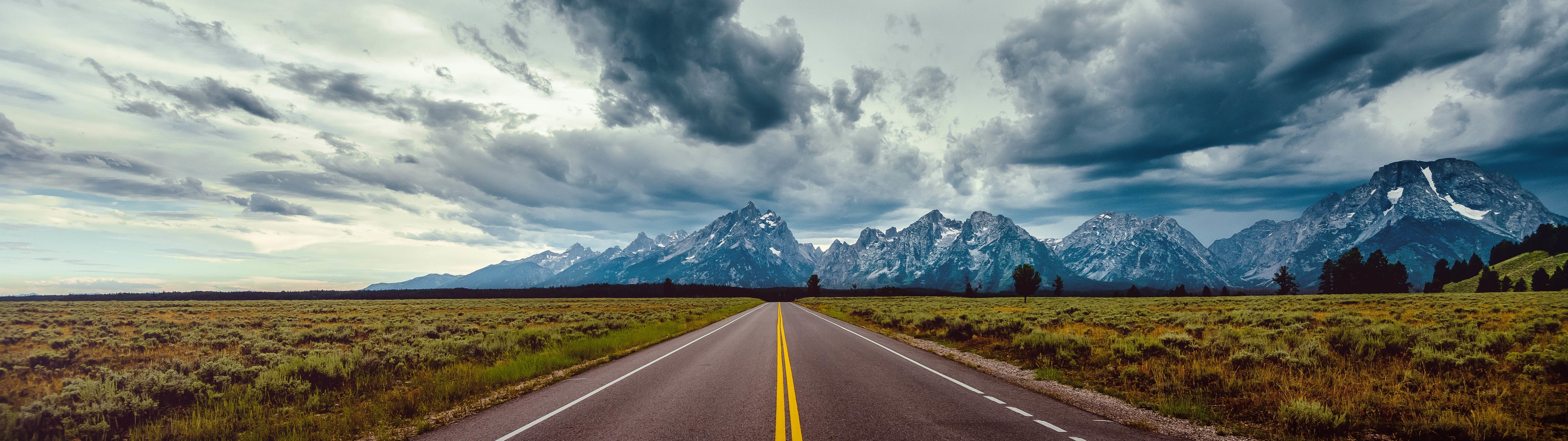 7680x2160 Download  Long Road, Mountains, Dark Clouds, Scenic Wallpaper, Dual Screen