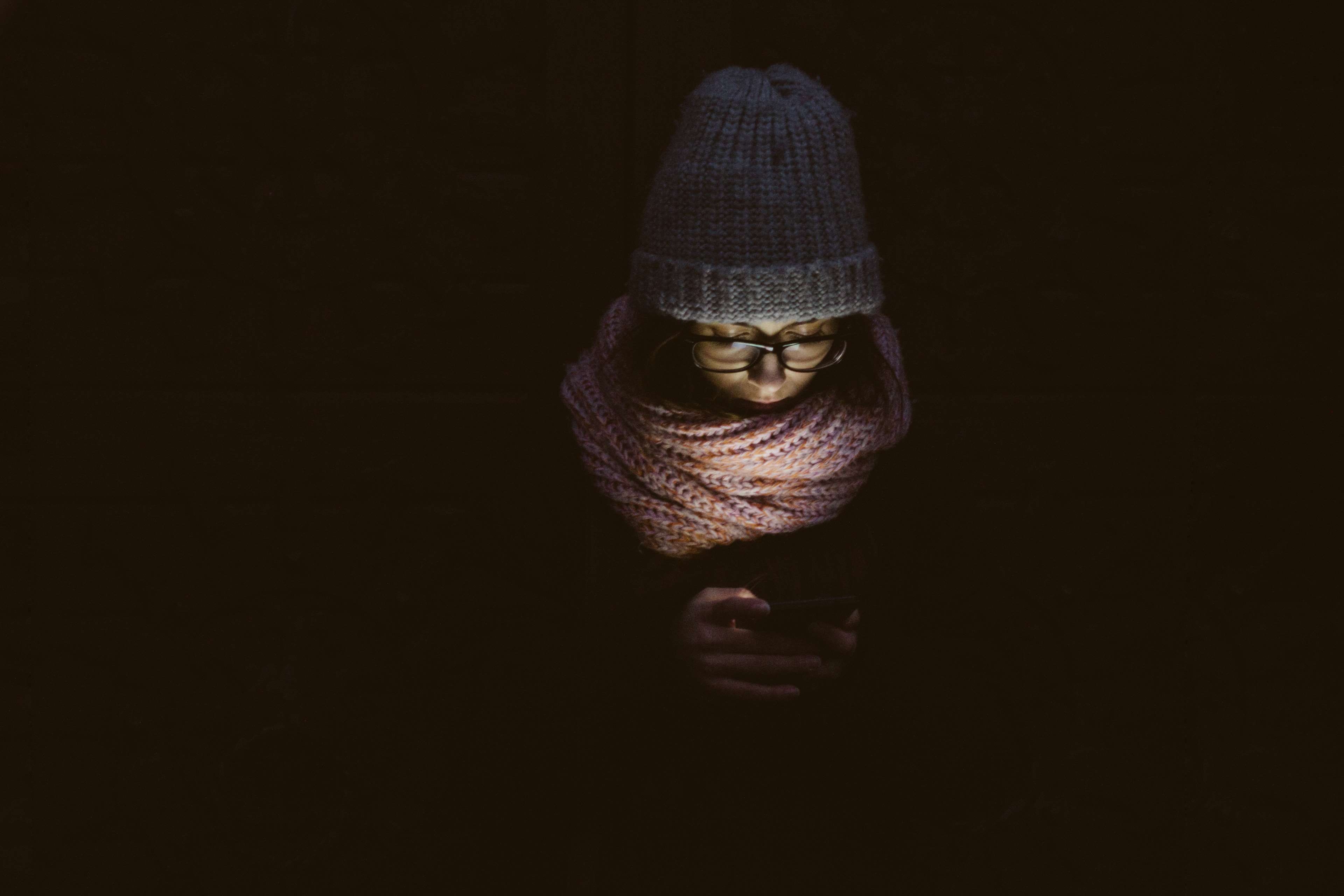 3840x2560 adult, art, dark, darkness, eyeglasses, face, fashion, girl, hat, light, mobile phone, person, reading, scarf, woman 4k wallpaper, Desktop