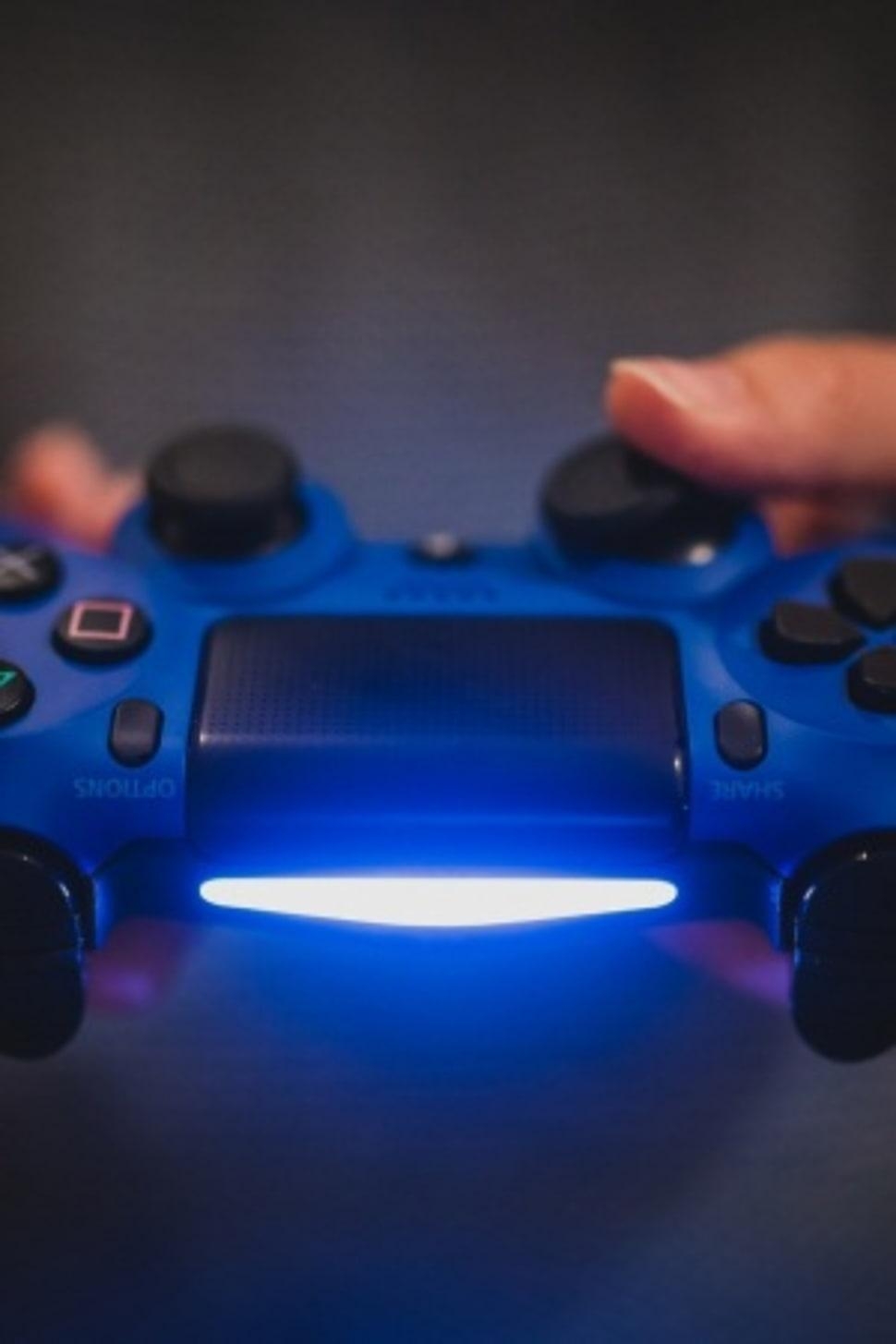 970x1460 Person holding blue Sony PS4 controller HD wallpaper, Phone