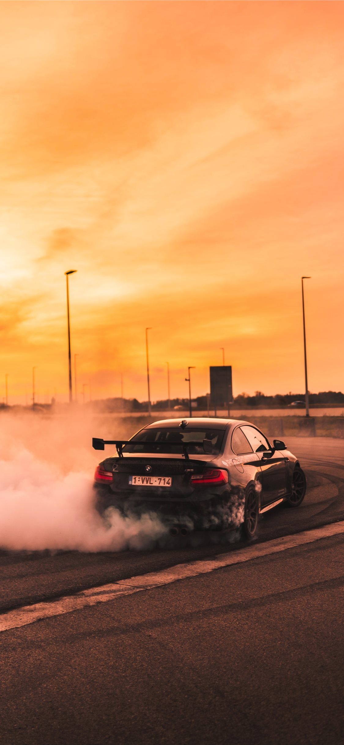 1130x2440 black car drifting on road during day. Car wallpaper, Car iphone wallpaper, Black car wallpaper, Phone