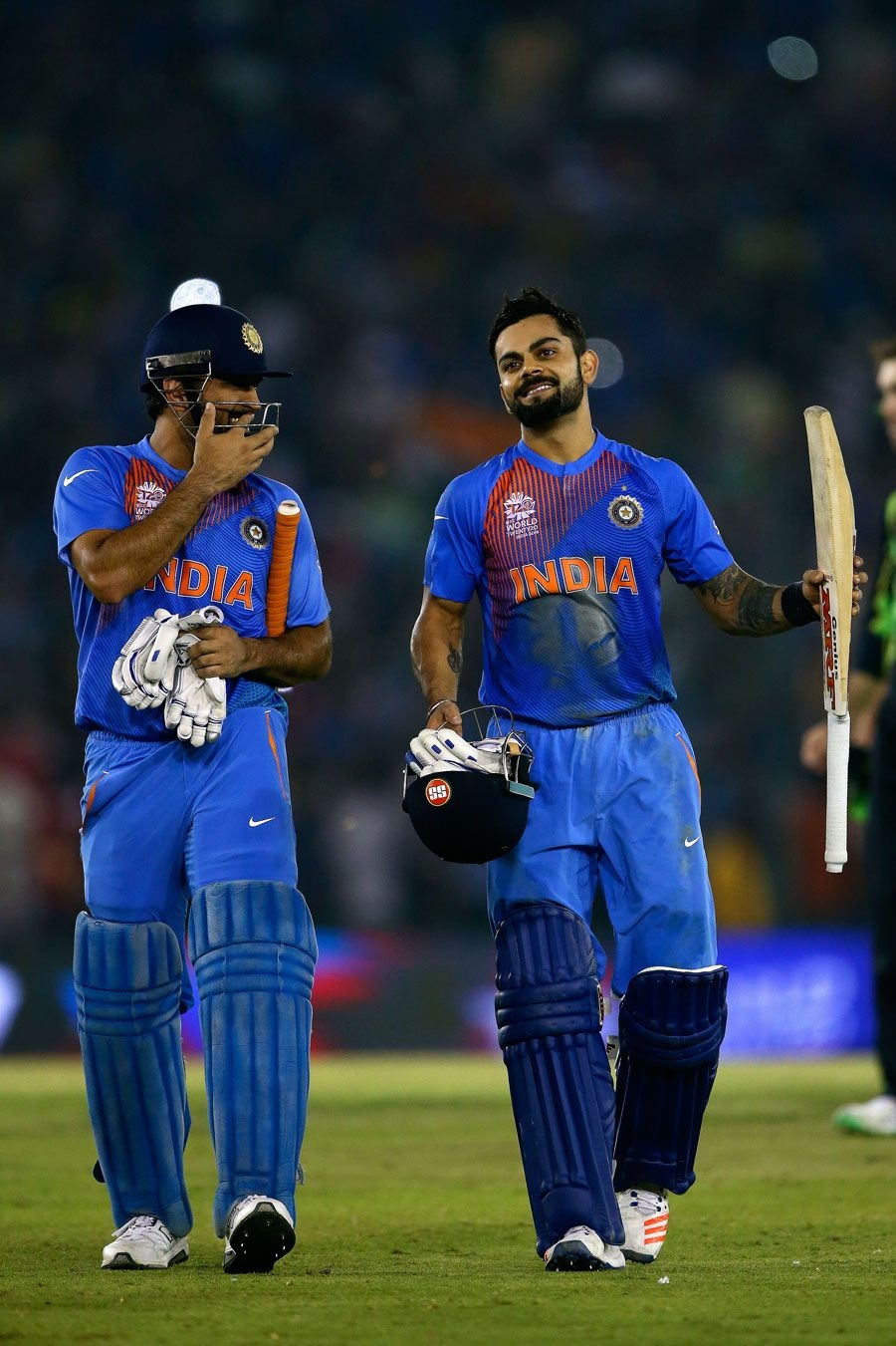 900x1360 MS Dhoni and Virat Kohli share a laugh after taking India home, Phone