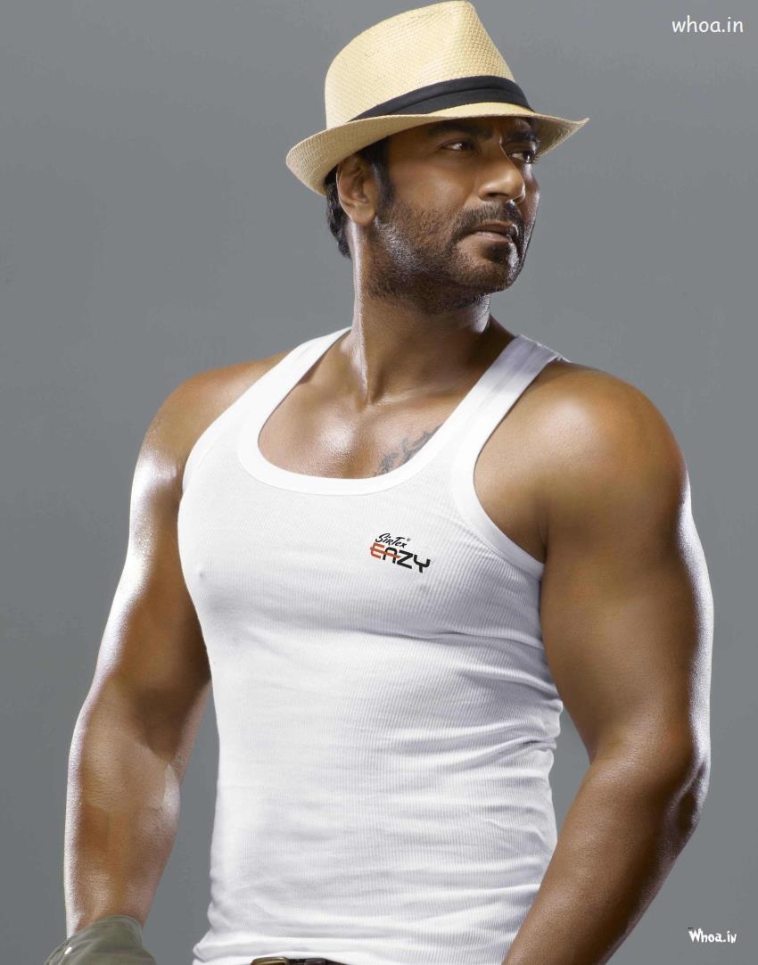 850x1090 Ajay Devgan Body Shapes With Cap HD Bollywood Actor Wallpaper, Phone