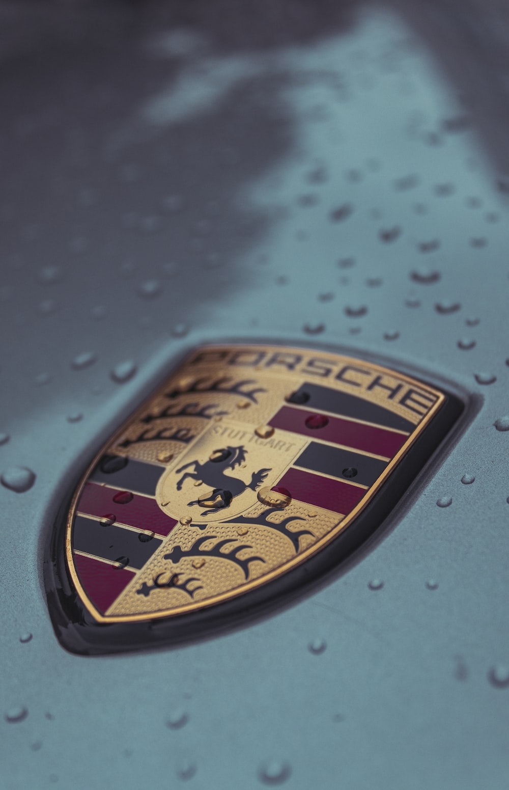 1000x1560 A close up of a porsche emblem on a car photo, Phone