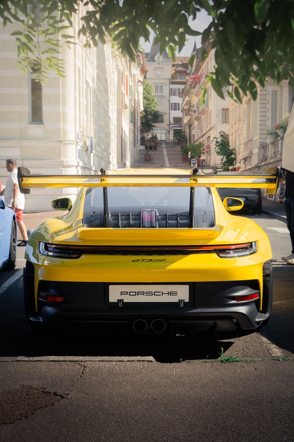 1000x1500 A yellow sports car parked on the side of the road photo, Phone