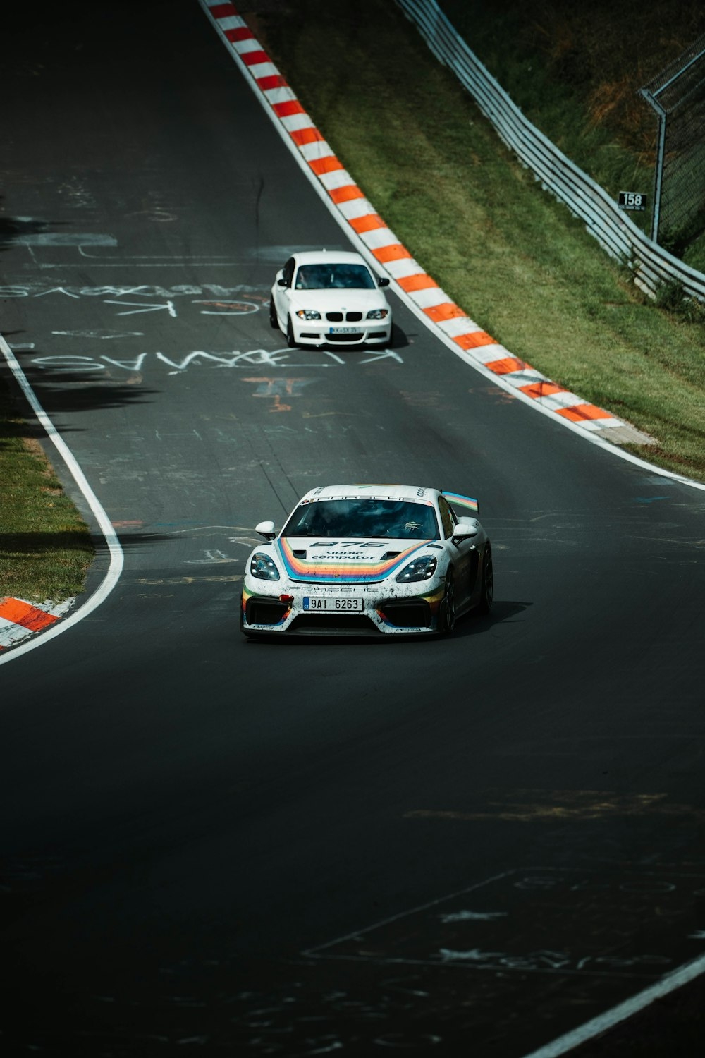 1000x1500 cars driving down a race track, Phone