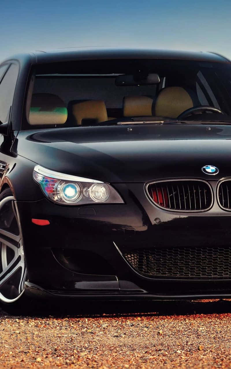 800x1280 Download A black BMW M is featured alongside an iPhone Wallpaper, Phone