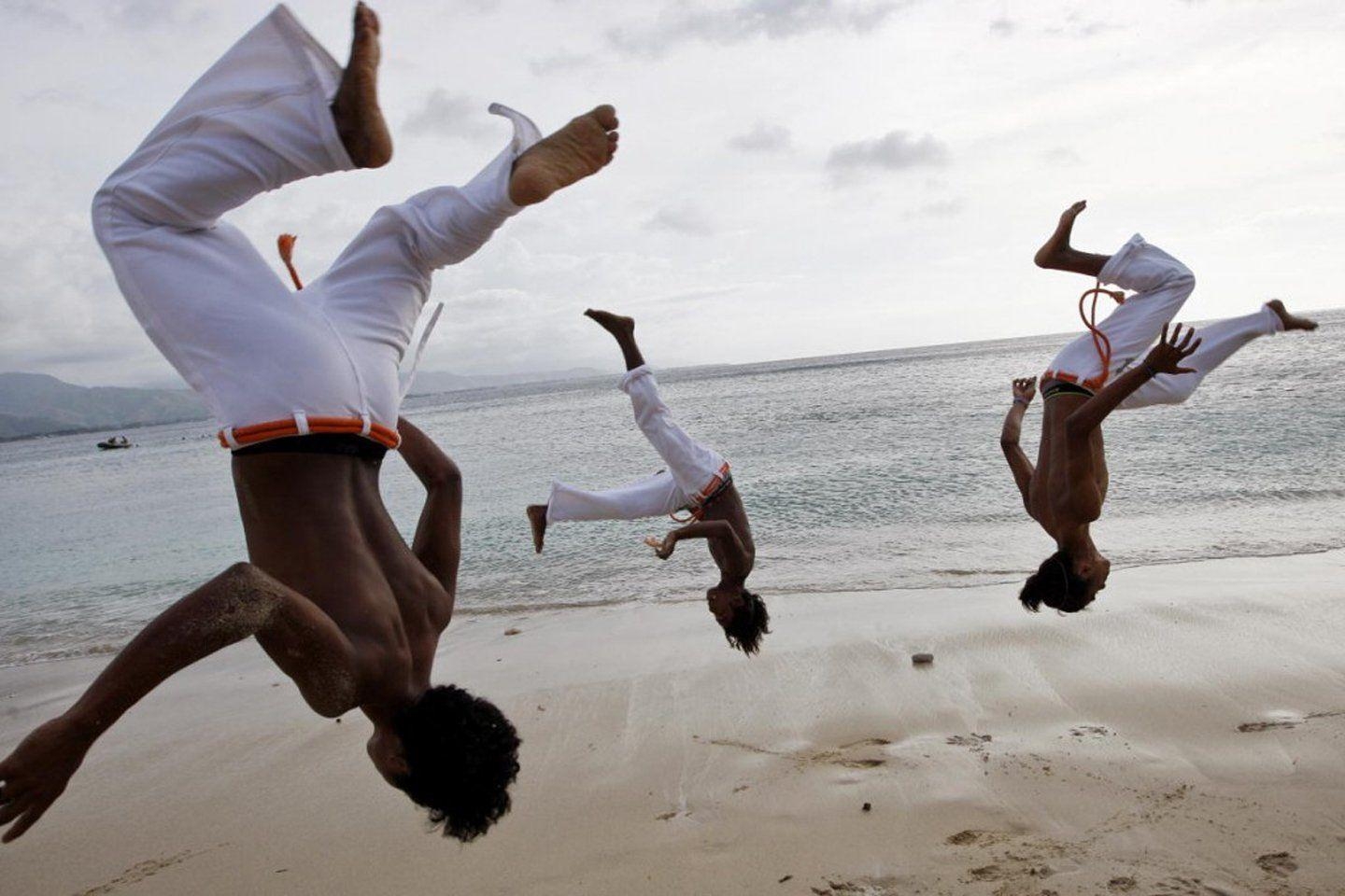 1440x960 A group of men practice capoeira on the beach in Dili wallpaper, Desktop